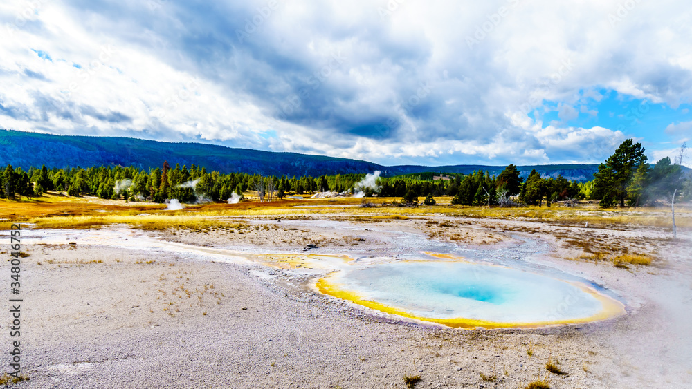 Steam coming from the colorful Chum Geyser in the Upper Geyser Basin along the Continental Divide Trail in Yellowstone National Park, Wyoming, United States Steam coming from the colorful Chum Geyser in the Upper Geyser Basin along the Continental Divide Trail in Yellowstone National Park, Wyoming, United States