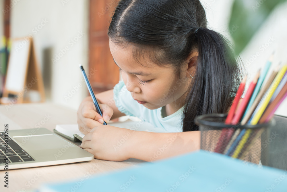 pretty stylish schoolgirl studying homework during online lesson at home, social distance during quarantine, self-isolation, online education concept, home school, study online video call teacher. pretty stylish schoolgirl studying homework during online lesson at home, social distance during quarantine, self-isolation, online education concept, home school, study online video call teacher.