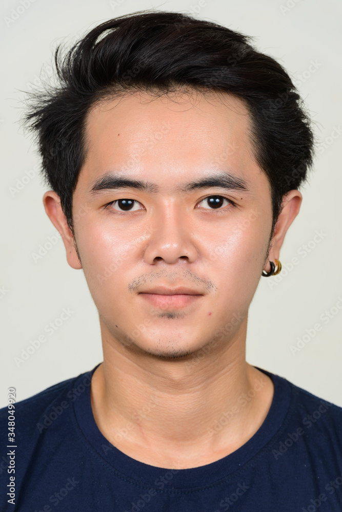 Portrait of young Asian man looking at camera Portrait of young Asian man looking at camera