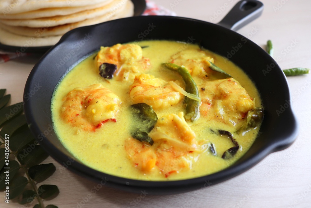 Yellow Prawns or Shrimp curry served with Amboli or Soft Dosa. Prawns cooked in coconut milk with mild spices. Prawns yellow Thai Curry. Goan fish Curry. Ingredients background with copy space. Yellow Prawns or Shrimp curry served with Amboli or Soft Dosa. Prawns cooked in coconut milk with mild spices. Prawns yellow Thai Curry. Goan fish Curry. Ingredients background with copy space.