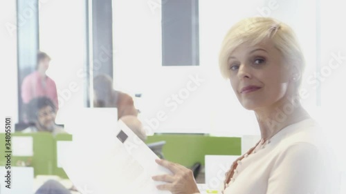 Senior woman working with her multi ethnic team in office

