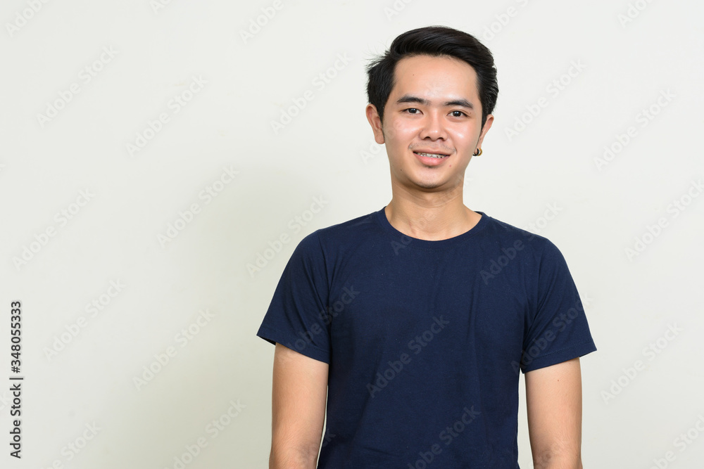 Portrait of happy young Asian man smiling Portrait of happy young Asian man smiling