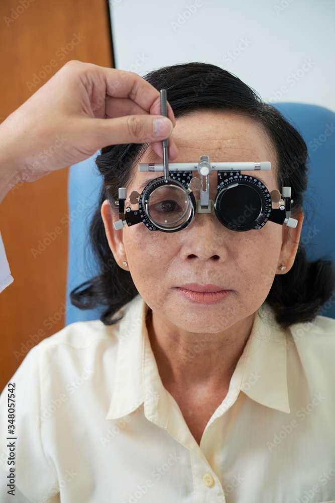 Senior Vietnamese woman having her eyes examined at ophthalmology clinic Senior Vietnamese woman having her eyes examined at ophthalmology clinic