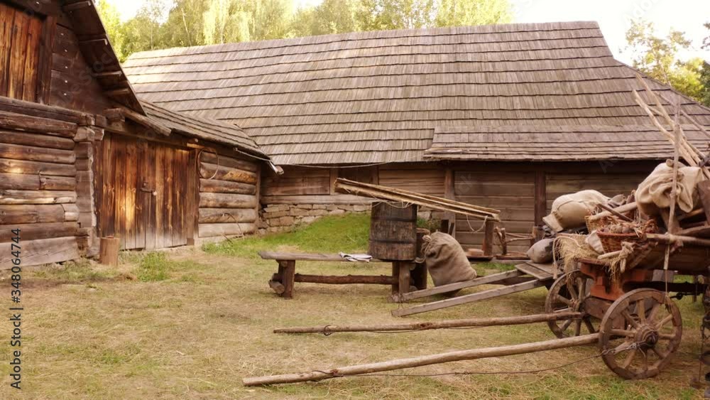 Medieval log cabin in the forest. Old medieval european farmhouse with carts of food. Stock 비디오