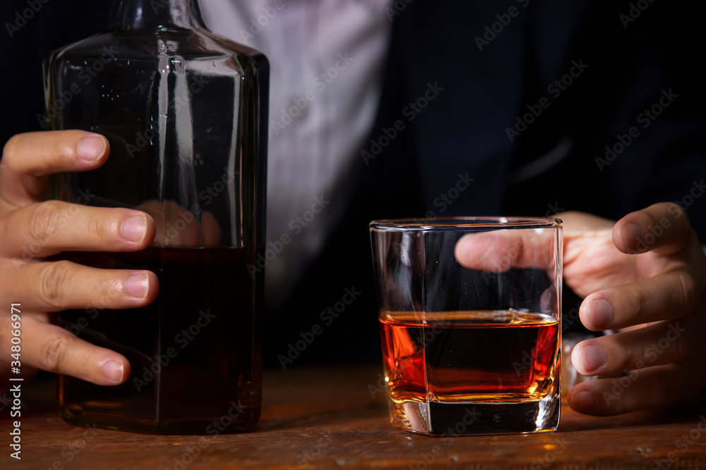 Closeup businessmen holding a glass of whiskey Closeup businessmen holding a glass of whiskey