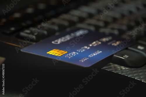 Shallow focus Credit Card on Computer keyboard. Background for E-commerce and online shopping concept.
