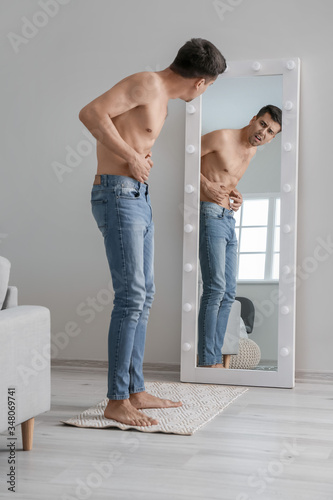 Young man with anorexia loo...