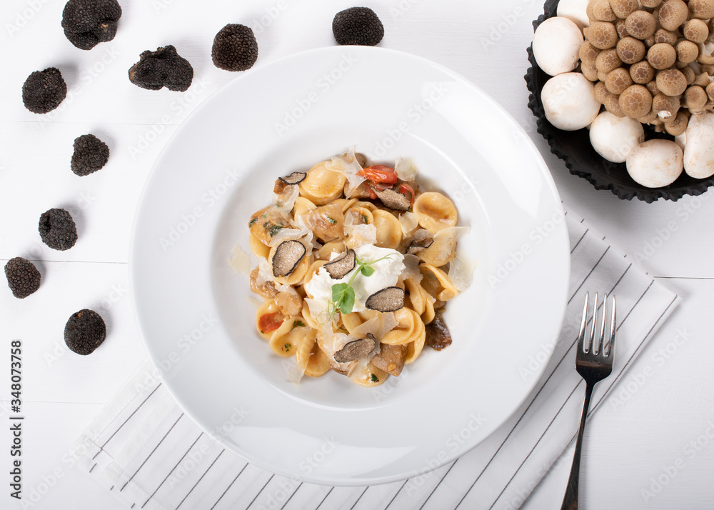 Orecchiette pasta with ceps, cherry tomatoes, ricotta gratin, fresh truffles and wild mushrooms