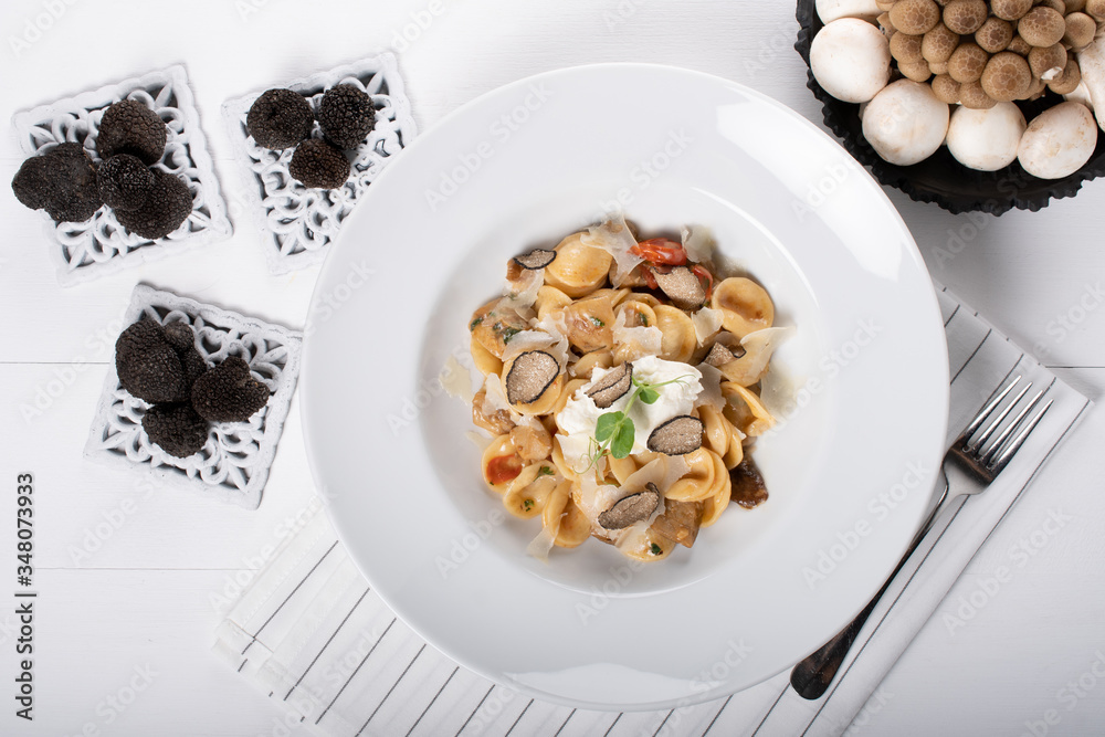 Orecchiette pasta with ceps, cherry tomatoes, ricotta gratin, fresh truffles and wild mushrooms Orecchiette pasta with ceps, cherry tomatoes, ricotta gratin, fresh truffles and wild mushrooms