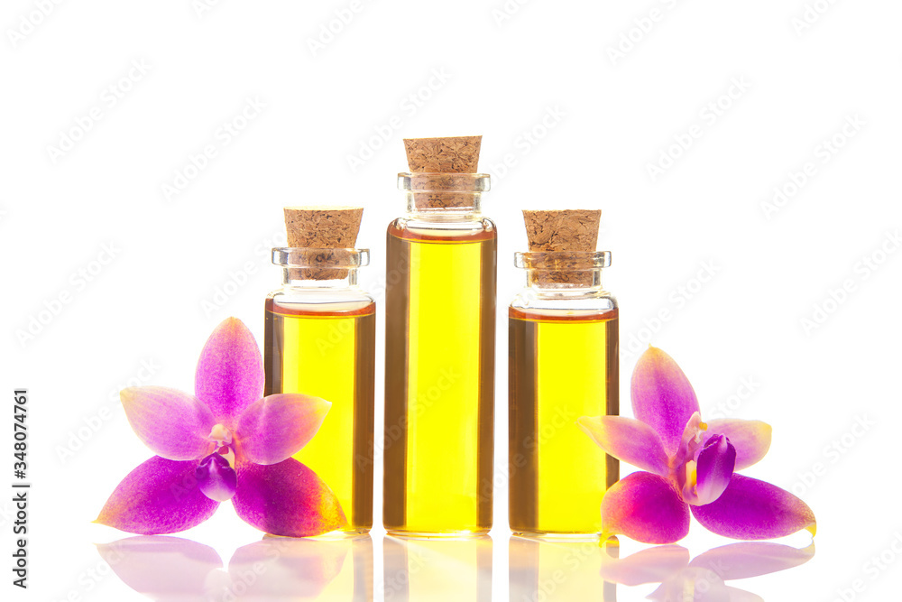 Essence of orchid flowers on table in beautiful glass jar Essence of orchid flowers on table in beautiful glass jar