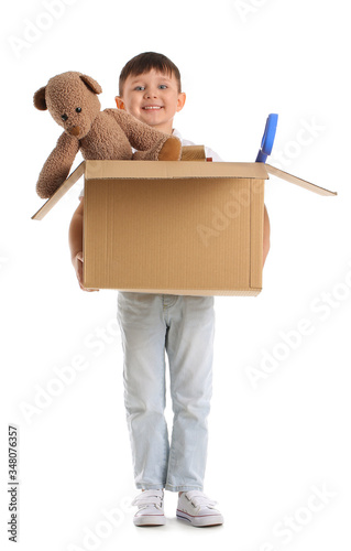 Little boy with toys on whi...