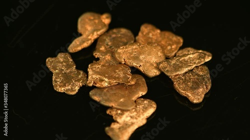 Rotating gold nugges (close up footage; selective focus)