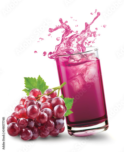 Glass of splashing grape juice with grape fruit on white background photo