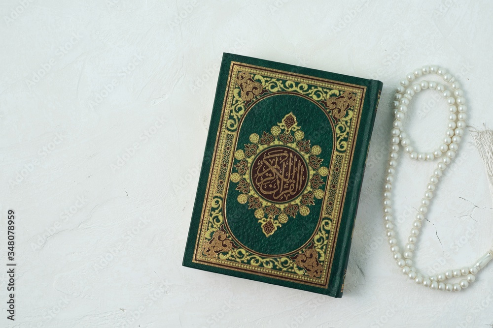 Holy Quran with written arabic calligraphy meaning of Al Quran on white background. Holy Quran with written arabic calligraphy meaning of Al Quran on white background.