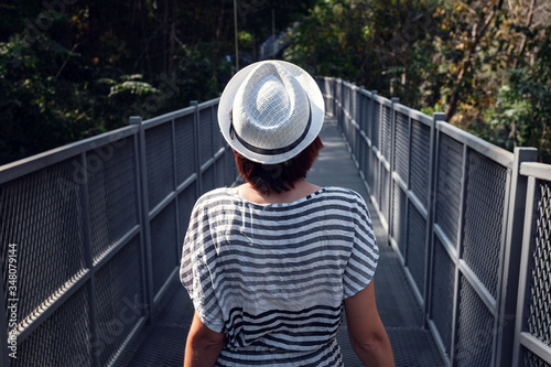 Woman standing alone on Canopy walkway at Queen Sirikit Botanic Gardens