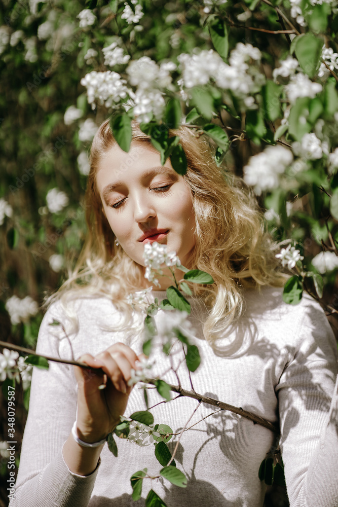 Fototapeta premium beautiful girl portrait on a background of blooming trees