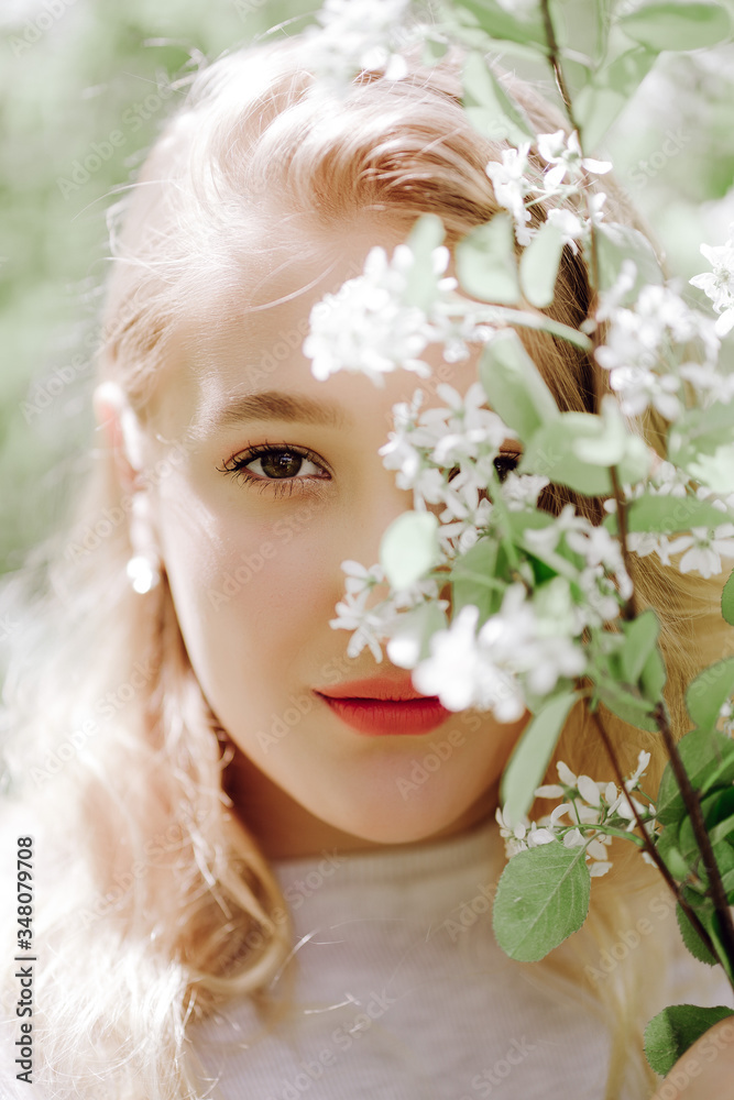 beautiful girl portrait on a background of blooming trees beautiful girl portrait on a background of blooming trees