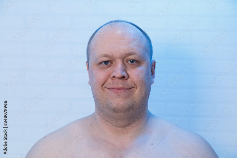A bald man smiles at the camera. Positive mood. A bald man smiles at the camera. Positive mood.