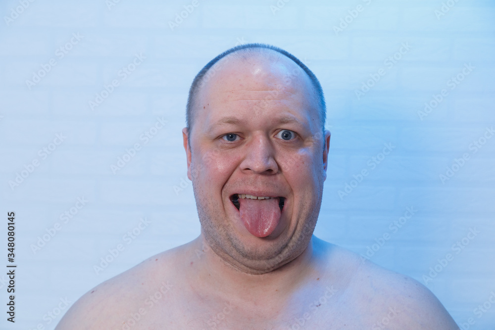 Portrait of a bald man who shows tongue. Portrait of a bald man who shows tongue.