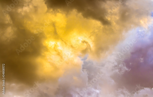 Yellow light in gray fume clouds with dim sky