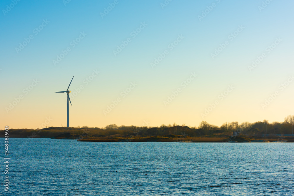A lonely wind turbine by the sea