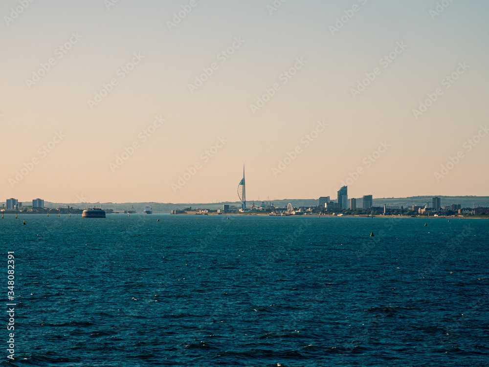 Panoramic view on the buildings of Portsmouth from the cruise ship in ocean