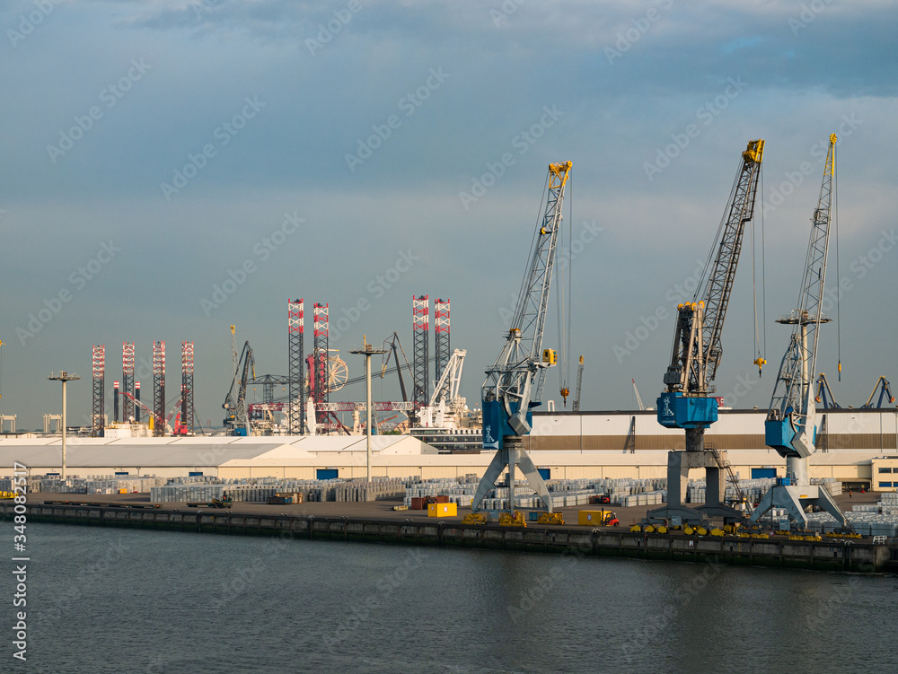 Rotterdam, Netherlands - May 08, 2020: evening view on the cargo port buildings infrastructure from the cruise ship