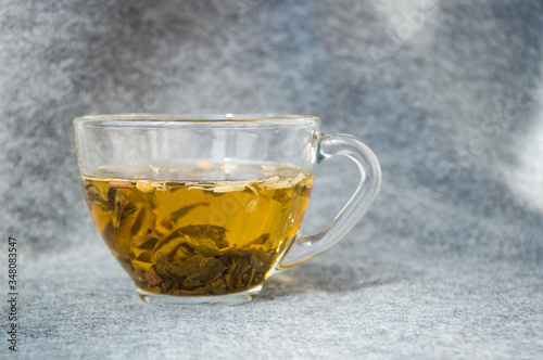 glassy cup with green leaf tea 