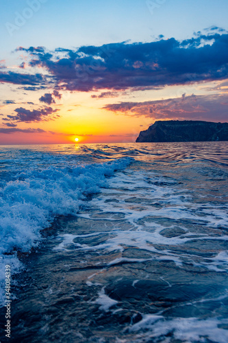 Raging sea waves at sunset in the ocean. Storm clouds on the sea.