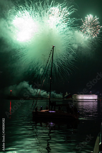 Close-up photo of a firework at night in the sea. Fireworks for the holiday. Background.