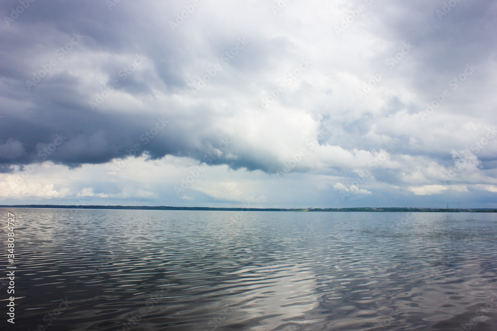 Clouds on the lake in rainy weather. Foggy morning.