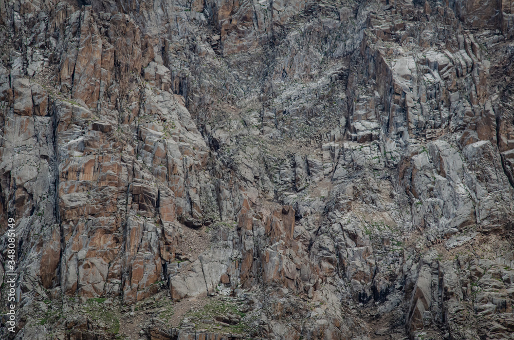 andscape of high rocky mountains with glacier snow-capped peaks and people watching this beauty