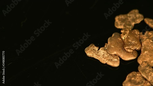 Rotating gold nugges (close up footage; selective focus)