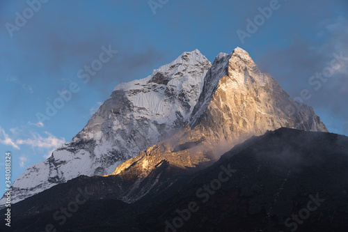 Evening sunset light over Ama Dablam mountain peak in Everest base camp trekking route, Himalaya mountains range in Nepal