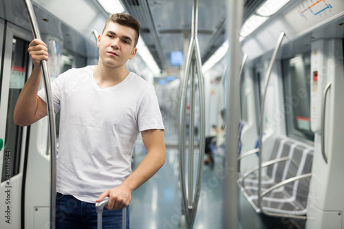 Man standing in underground carriage