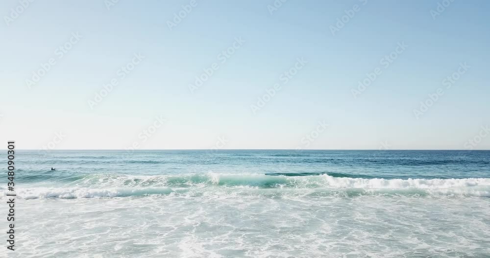 Blue foam wave rolls on to the deserted shore of the ocean Blue foam wave rolls on to the deserted shore of the ocean
