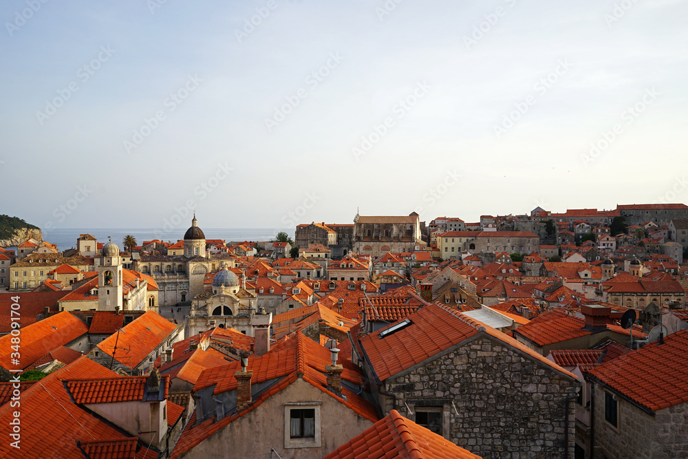 Exterior architecture and design of Dubrovnik old town city walls and landscape with clear blue sky, southern Croatia fronting the Adriatic sea encircled with massive stone Exterior architecture and design of Dubrovnik old town city walls and landscape with clear blue sky, southern Croatia fronting the Adriatic sea encircled with massive stone