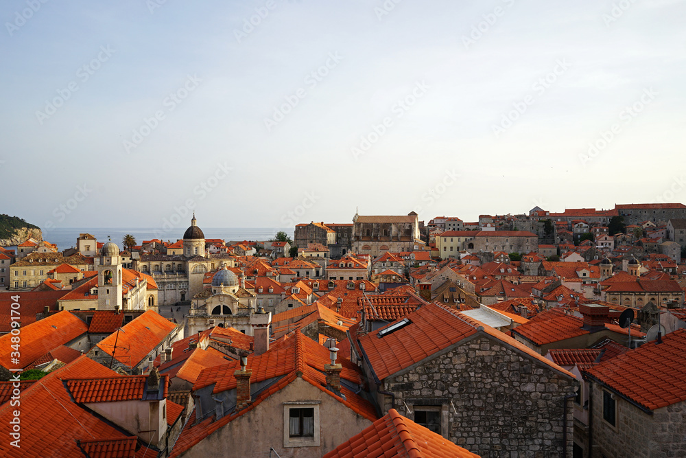 Exterior architecture and design of Dubrovnik old town city walls and landscape with clear blue sky, southern Croatia fronting the Adriatic sea encircled with massive stone