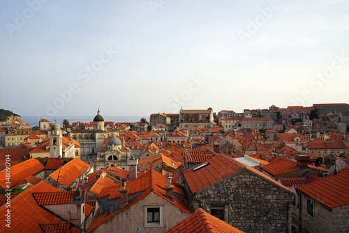 Exterior architecture and design of Dubrovnik old town city walls and landscape with clear blue sky, southern Croatia fronting the Adriatic sea encircled with massive stone