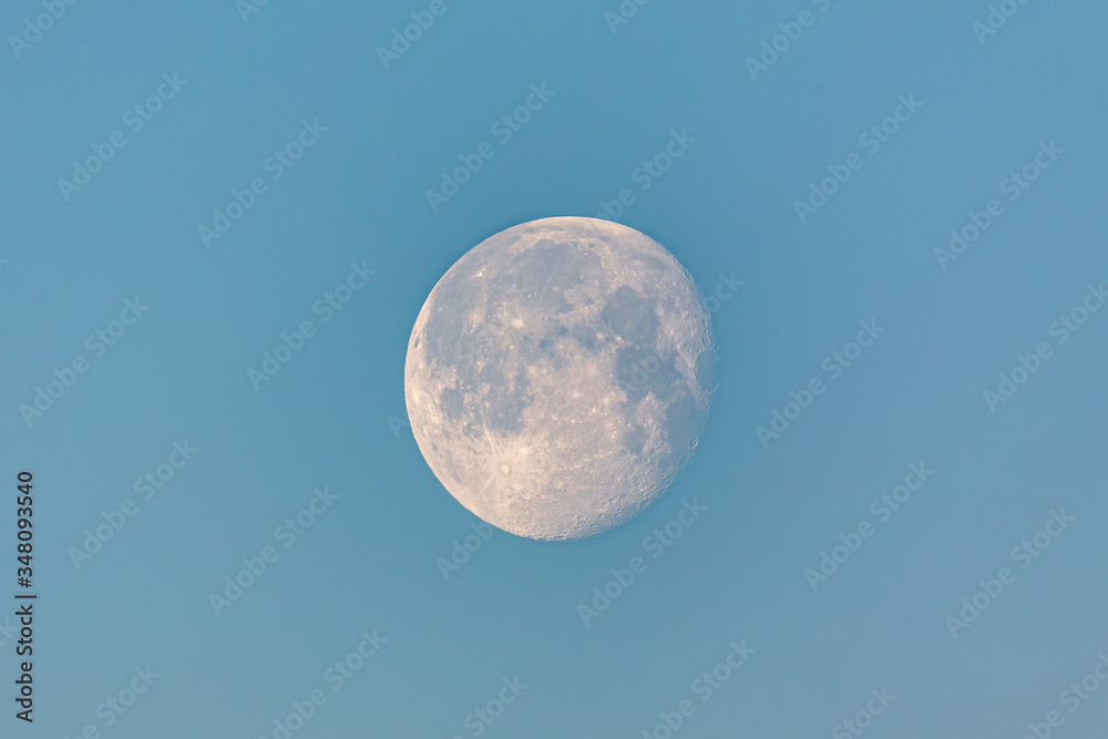 Almost full moon at early morning on a blue sky. Almost full moon at early morning on a blue sky.