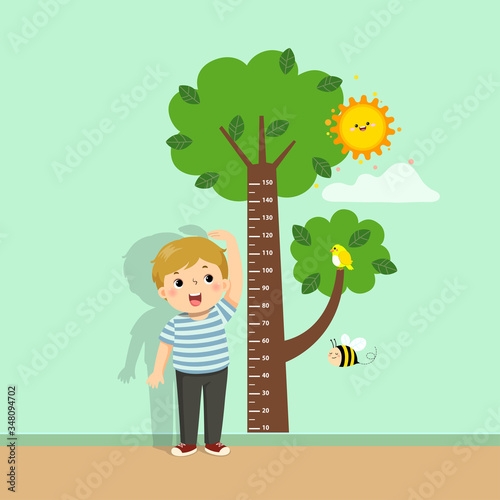 Vector illustration cute cartoon boy measuring his height with tree height chart on the wall.