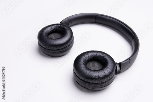 Black headphones . White background. Copy, text space