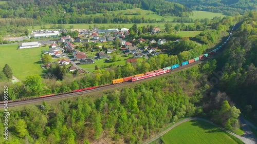 freigt train and passenger train passing each other on a bridge photo