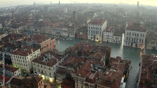 Aerial, drone shot panning towards the canal Grande, revealing ferries on the Canalaso, on a sunny evening, in Venice, Italy photo