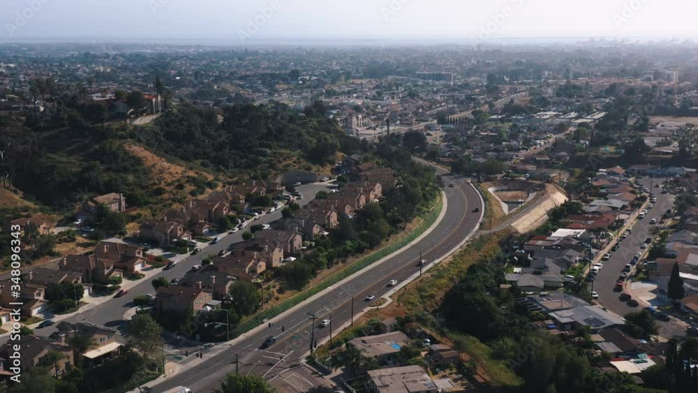 Aerial shot of residential houses and cars passing by it inside a small town Aerial shot of residential houses and cars passing by it inside a small town
