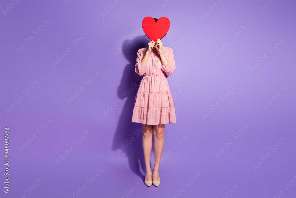 Full length photo of cute sweet lovely girl feel shy valentine day date close cover face red big paper card heart wear good look pastel clothes isolated violet color background Full length photo of cute sweet lovely girl feel shy valentine day date close cover face red big paper card heart wear good look pastel clothes isolated violet color background