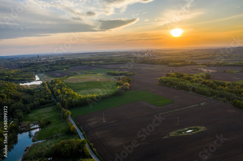 aerial view of sunset over field and forests