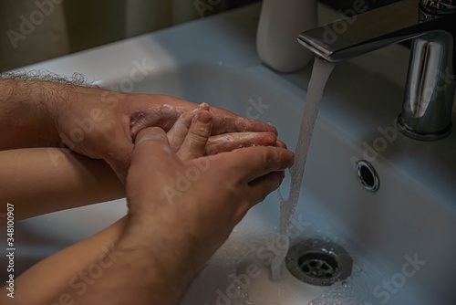 washing hands with soap.  Washing a child   s hands with soap and water to prevent coronavirus and hygiene to stop the spread of coronavirus. wash your hands with soap and hot water