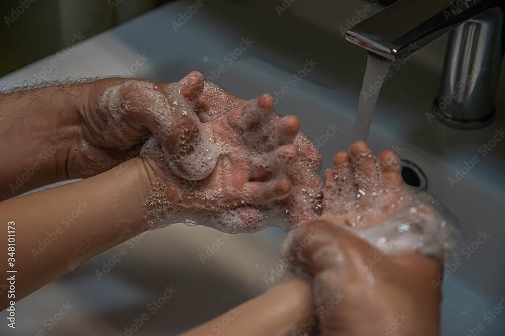 Fototapeta premium washing hands with soap. Washing a child’s hands with soap and water to prevent coronavirus and hygiene to stop the spread of coronavirus. wash your hands with soap and hot water