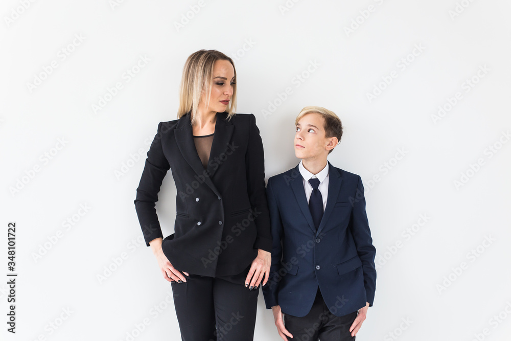 Teenager and single parent - Young mother and son standing together on white background. Teenager and single parent - Young mother and son standing together on white background.